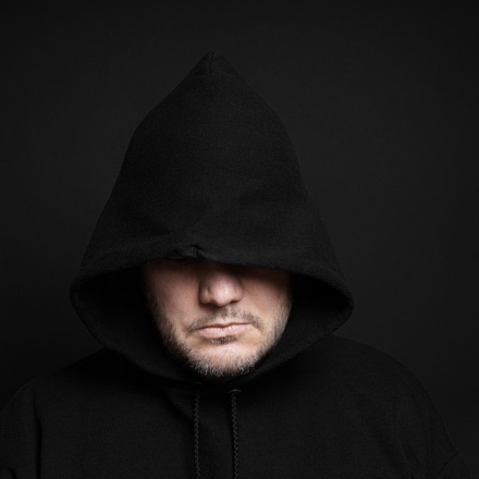 man wearing black hoodie hiding eyes